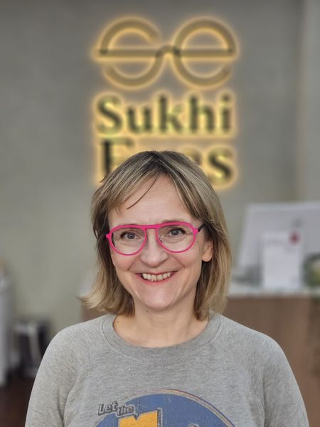 Guest smiling in hot-pink aviator-style frames
