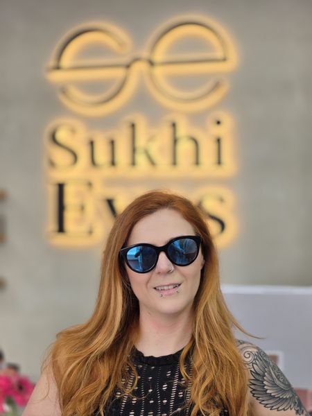 Guest in black cat-eye sunglasses with blue mirrored lenses
